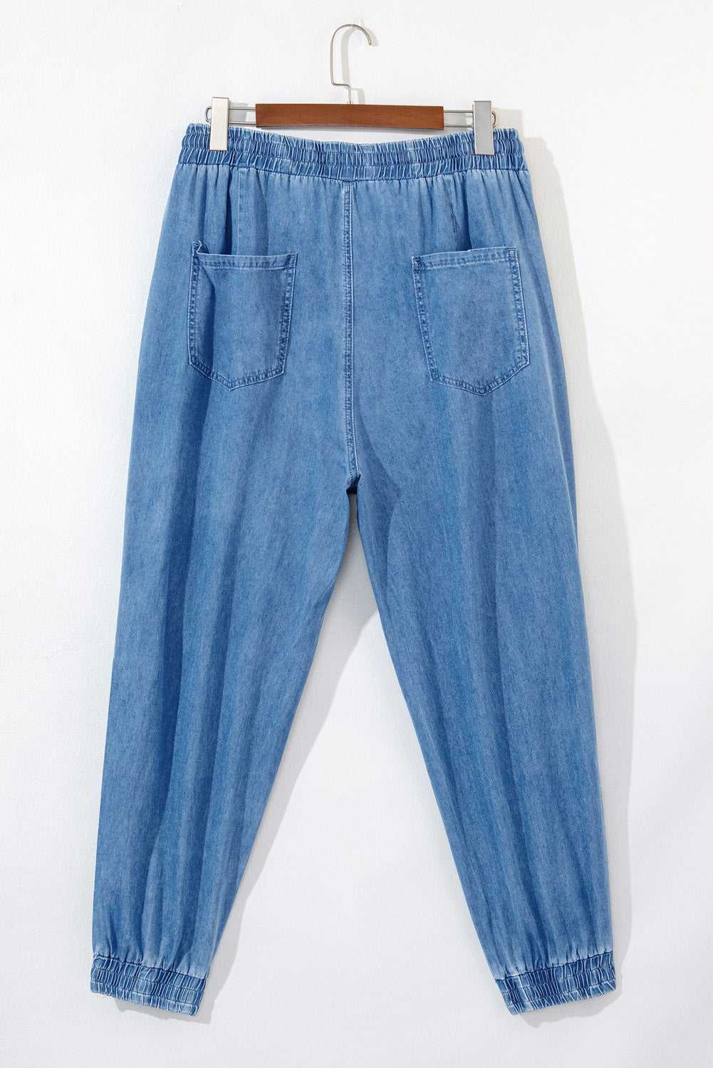 Rear flat lay of Plus Size Blue Denim Joggers showing elastic waistband and dual back pockets, crafted for casual plus size wear.
