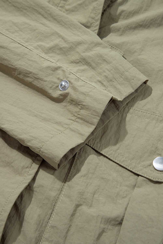 Sleeve and cuff detail of Cropped Hooded Utility Jacket with snap button, emphasizing durable stitching and casual design.