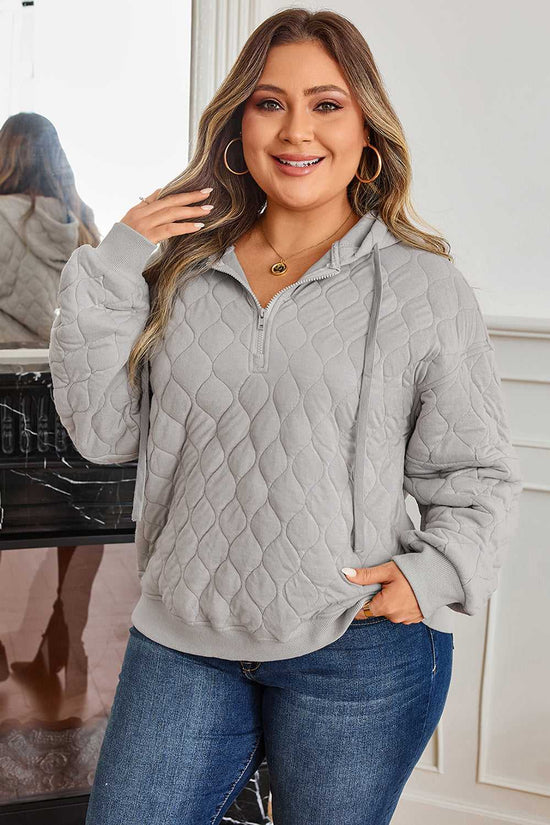 Front view of curve grey quilted quarter-zip hoodie for women with drawstring hood and ribbed cuffs, perfect for daily casual outfits.