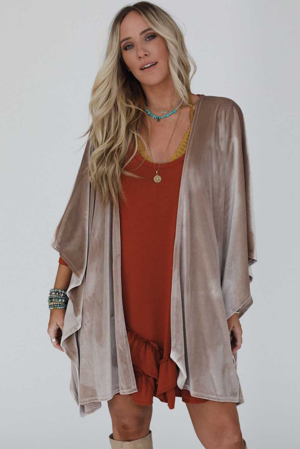 Draped velvet kimono paired with boots and neutral basics