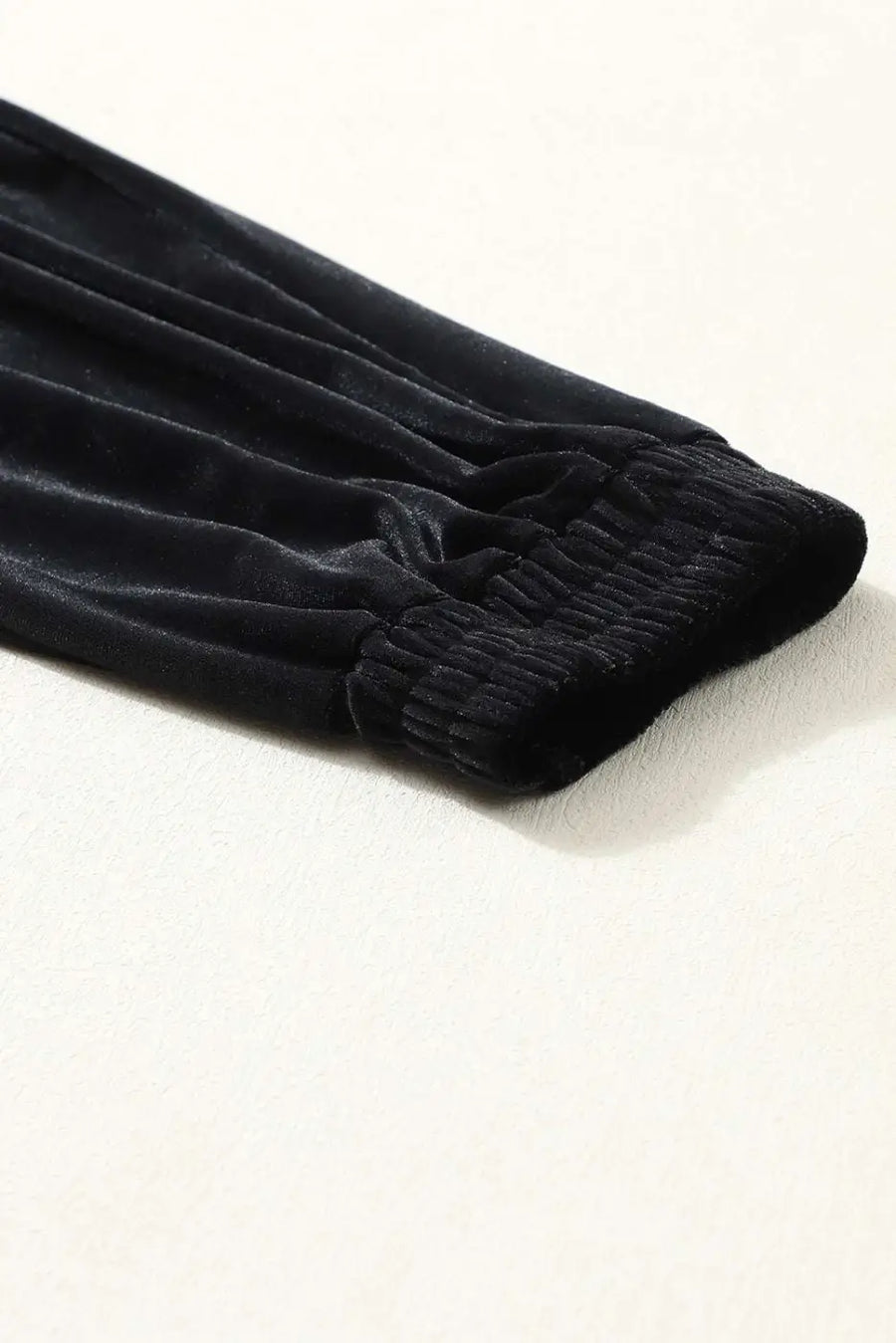 Elastic cuff detail of Black Velvet Jogger Trousers, designed for a snug ankle fit and enhanced comfort in women's loungewear.