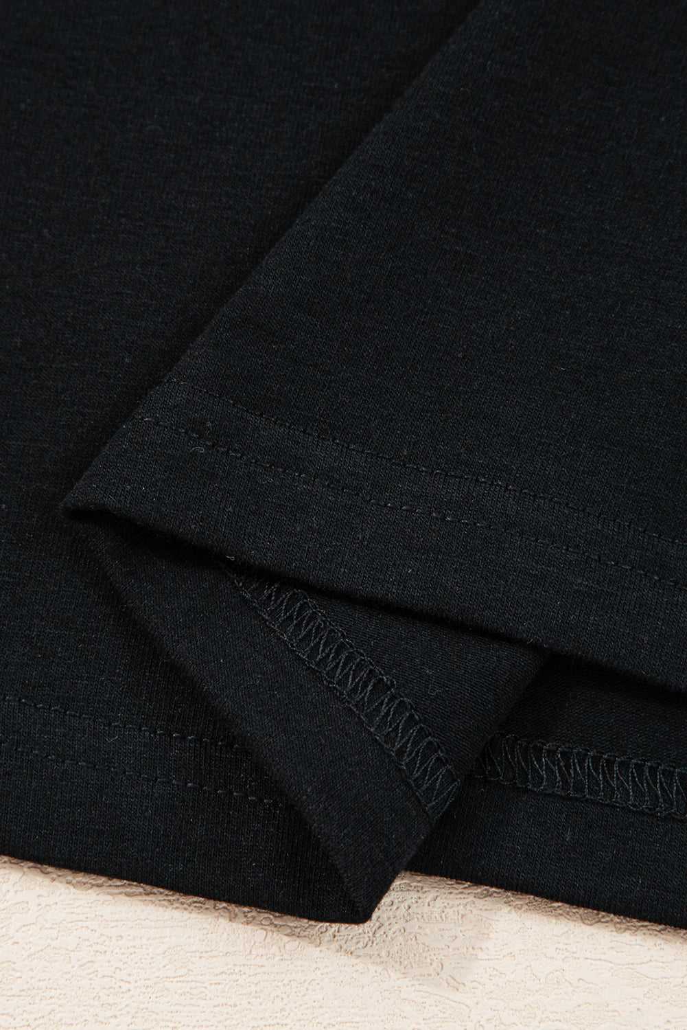 Hemline stitching detail of the Lace Sleeve Drop T-Shirt - Soft & Comfy | FashionFitz, featuring double-stitched black fabric for durability.