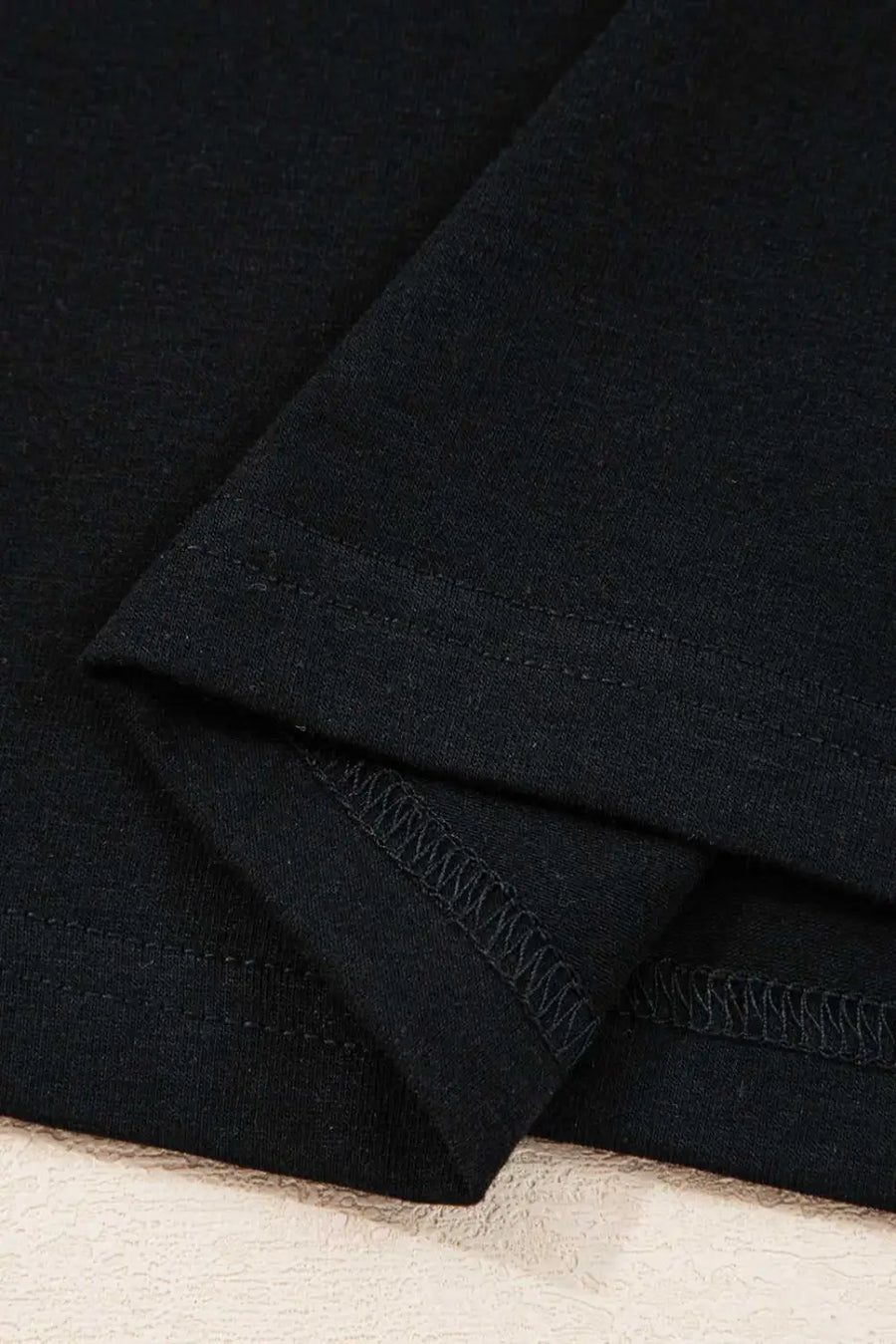 Hemline stitching detail of the Lace Sleeve Drop T-Shirt - Soft & Comfy | FashionFitz, featuring double-stitched black fabric for durability.
