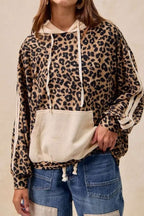 Ladies Leopard Print Waffle Knit Kangaroo Hoodie with beige drawstring hood and front pocket, styled with casual denim jeans.