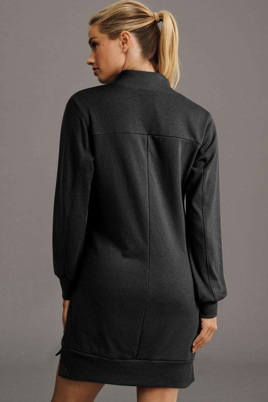 Back view of black zip-up sweatshirt mini dress featuring long sleeves and ribbed hem, perfect for daily autumn wear.