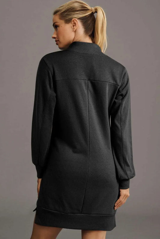 Back view of black zip-up sweatshirt mini dress featuring long sleeves and ribbed hem, perfect for daily autumn wear.