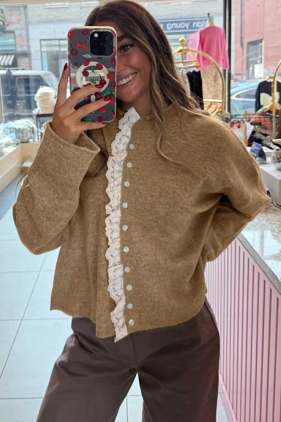 Relaxed fit taupe cardigan with lace trim and pearl-style buttons, styled for a feminine and cozy fall look. Lightweight layering knitwear.