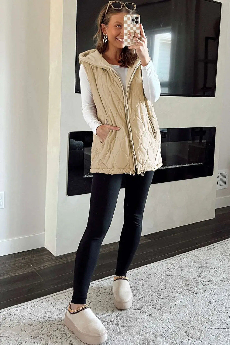 Full outfit featuring Quilted Fleece‑Lined Winter Gilet in khaki, layered over white top and black leggings with beige platform slippers.