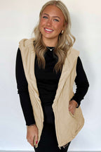 Front view of woman smiling in khaki Quilted Fleece‑Lined Winter Gilet with fleece interior and zippered pockets, paired with black outfit.