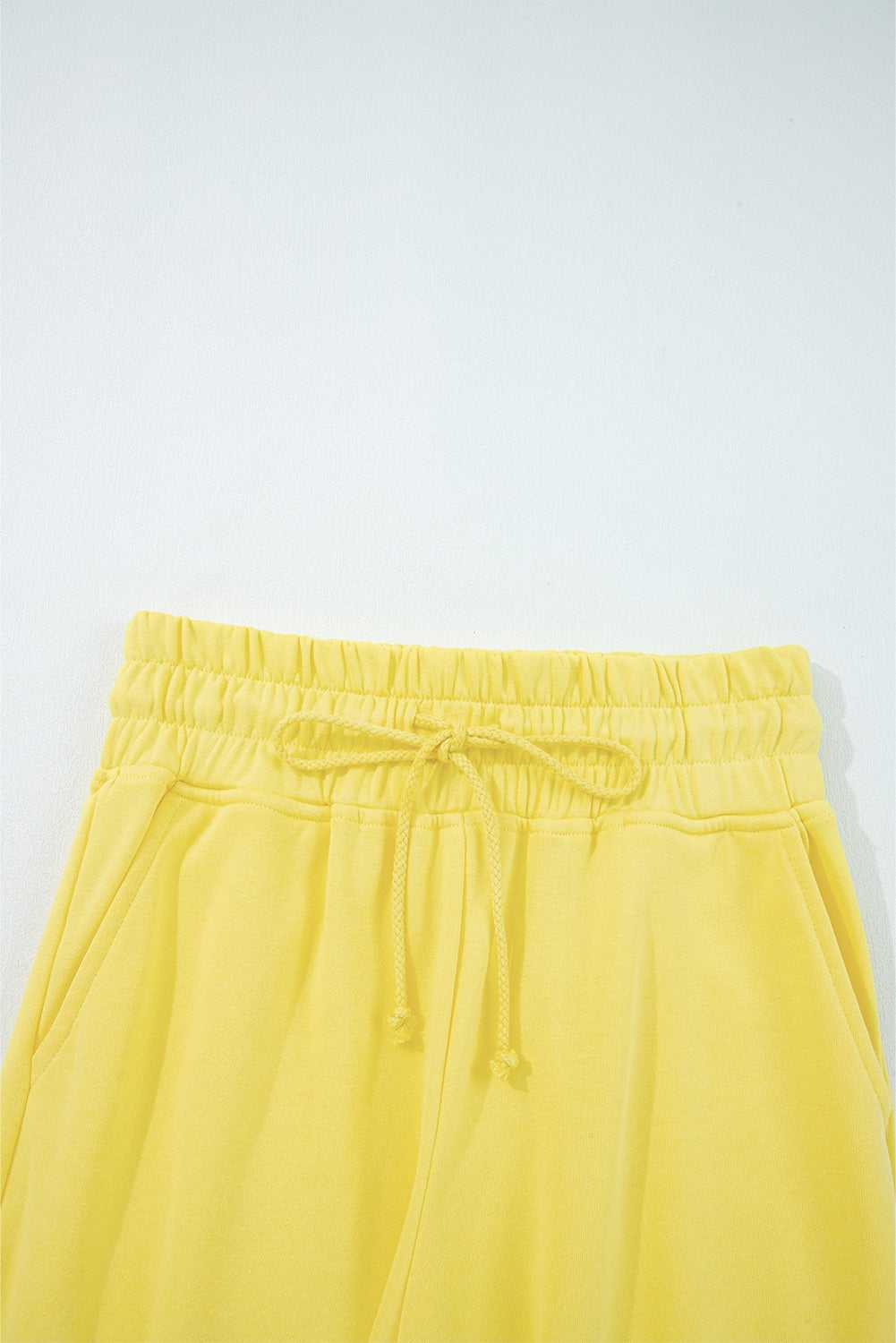 Elastic waistband and drawstring detail of yellow Drop Crop Wide-Leg Pants Set, designed for adjustable fit and ease.