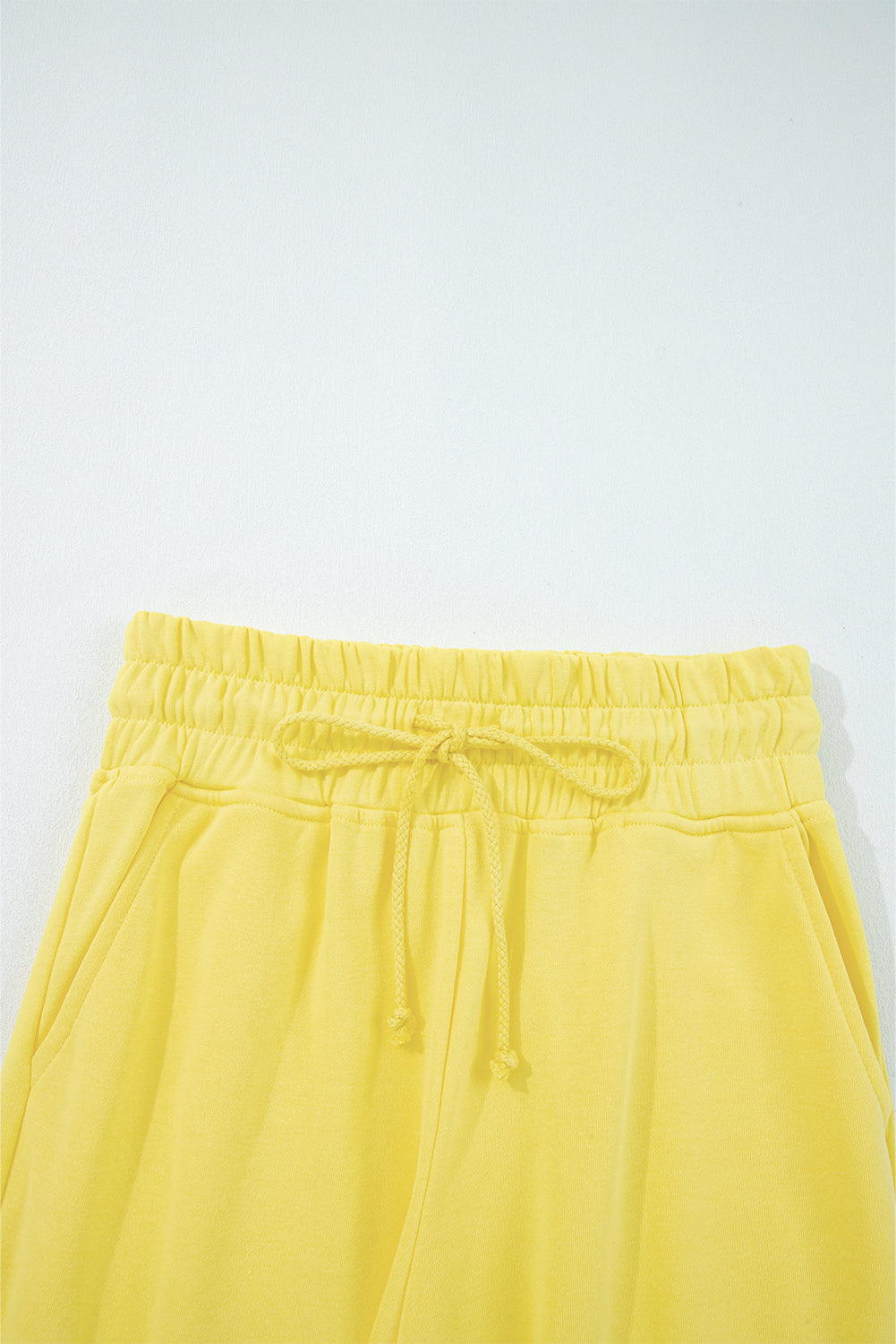 Elastic waistband and drawstring detail of yellow Drop Crop Wide-Leg Pants Set, designed for adjustable fit and ease.