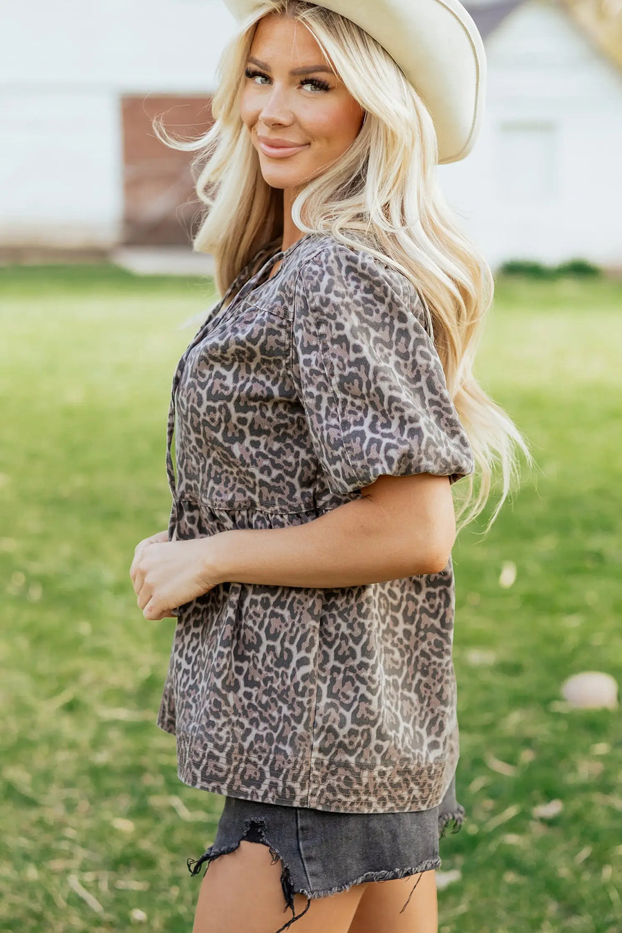 Side view of Leopard Tie Neck Puff Sleeve Babydoll Top showing tiered hem and puff sleeve structure — Fashionfitz