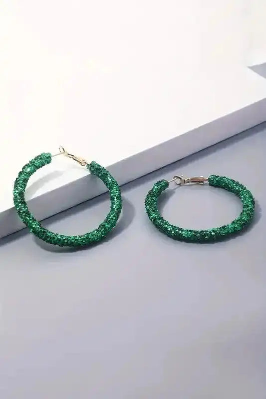 Pair of St. Patrick's Sequin Loop Earrings - Dark Green by Fashionfitz displayed on white and gray surface, showcasing festive sparkle design.