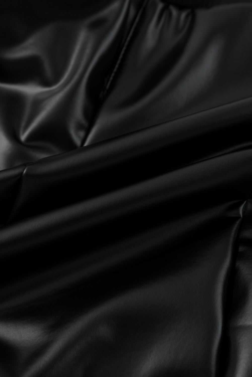 Texture detail of Black Vegan Leather Leggings – High‑Rise Skinny Fit highlighting soft, glossy PU leather with stretch comfort.
