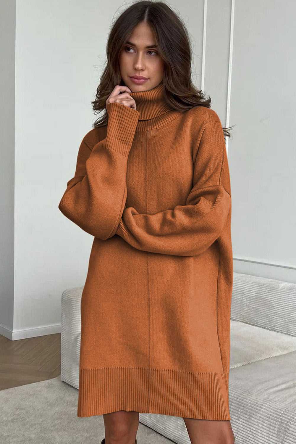 Woman wearing a brown Oversized Turtleneck Jumper Dress in a minimal indoor setting