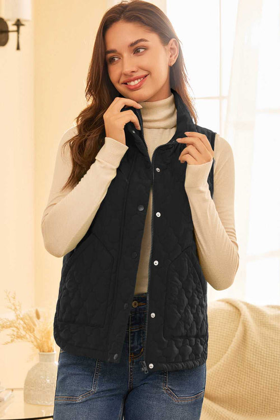 Black Flower‑Quilted Winter Gilet worn over turtleneck indoors, highlighting zip and snap-button fastening for cozy and stylish winter wear.