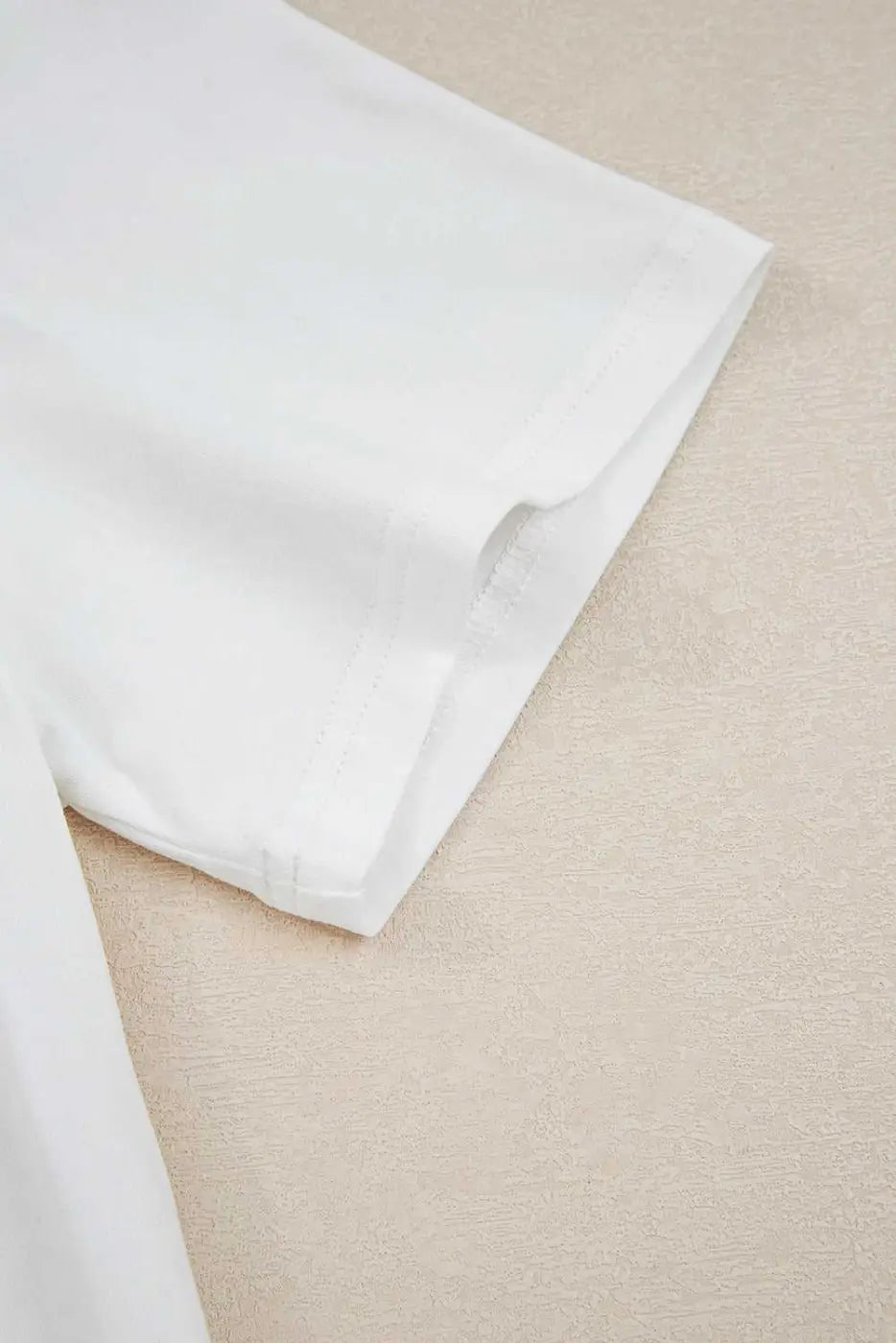 Detail of the short sleeve hem on the 'Mama Claus' tee from the Ladies Nutcracker Christmas Lounge Set by FashionFitz UK, highlighting stitching quality.