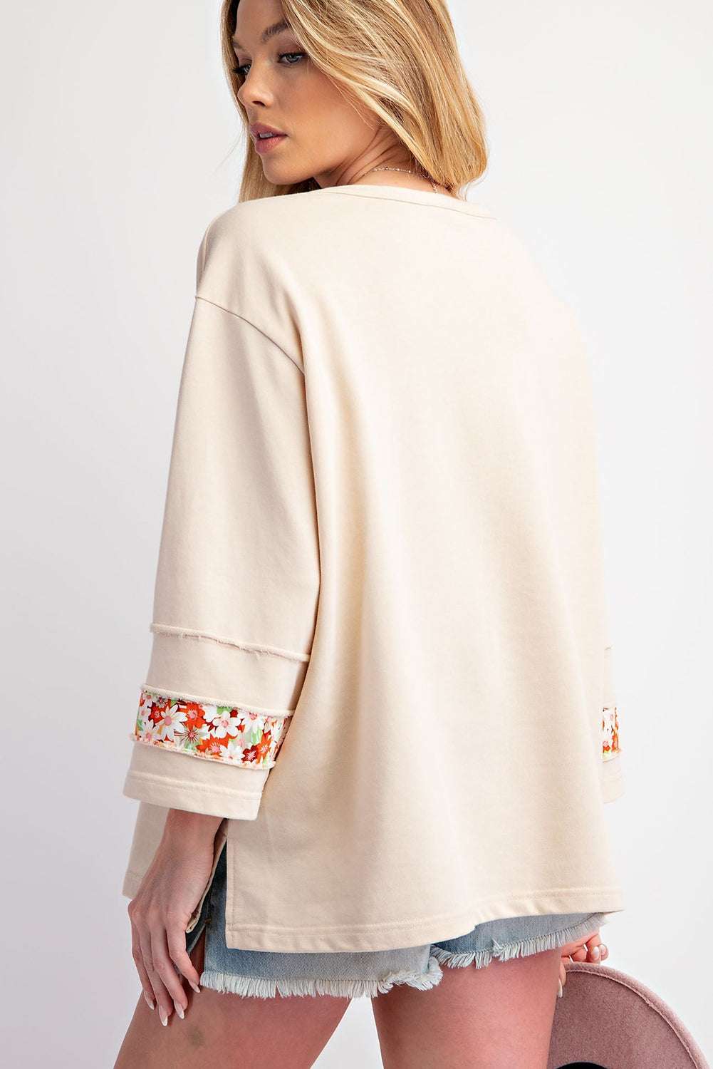 Back view of Beige Flower Patch Graphic Top showing loose fit and floral sleeve accents, ideal for relaxed spring outfits.