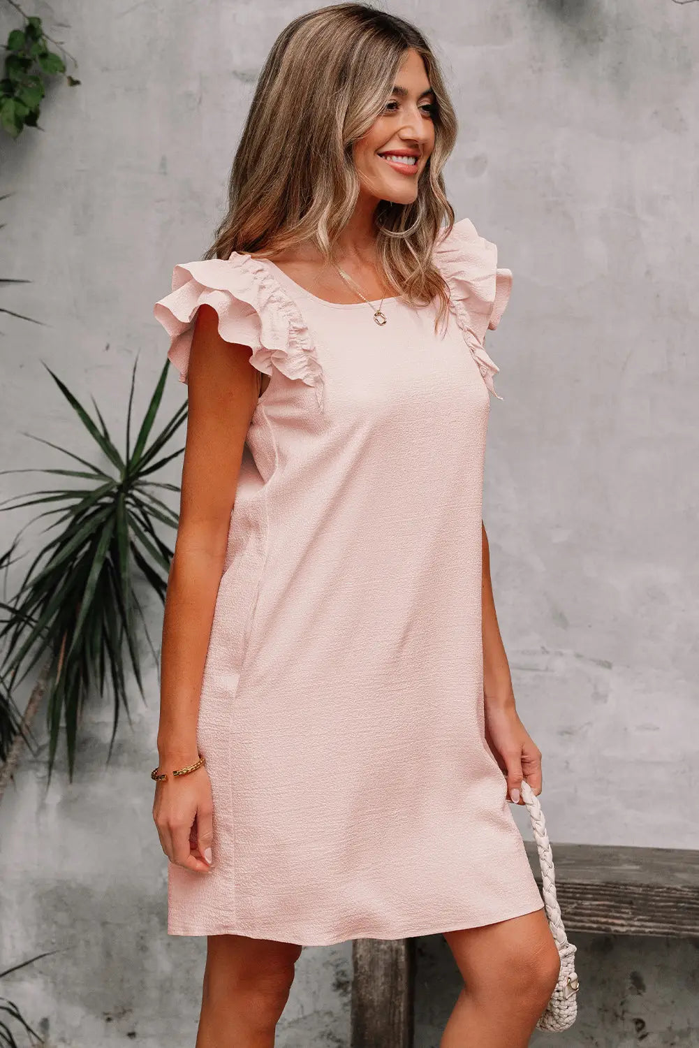 Light pink textured flutter sleeve square neck bow back mini dress