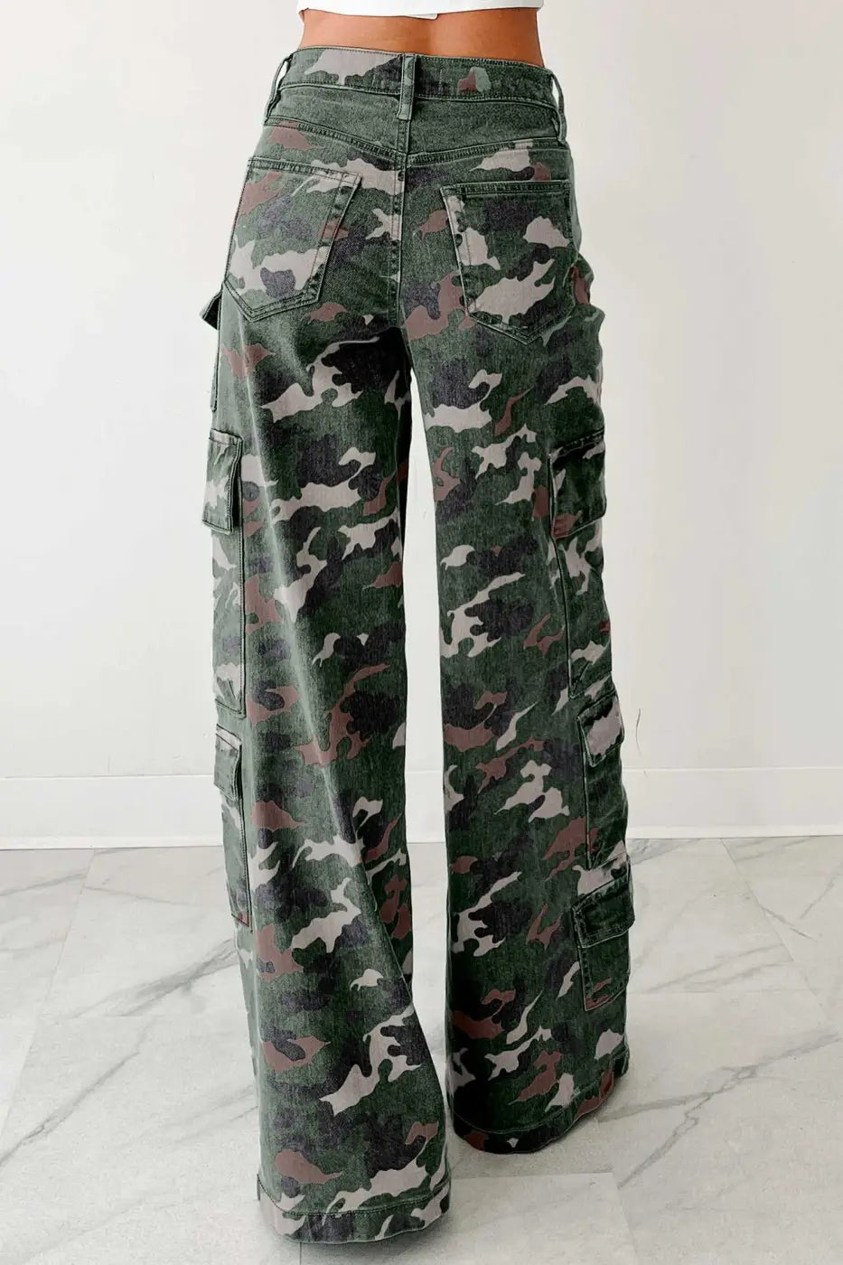 Back view of wide leg camo cargo jeans for women with flap pockets and high waist. Durable green denim with relaxed fit.