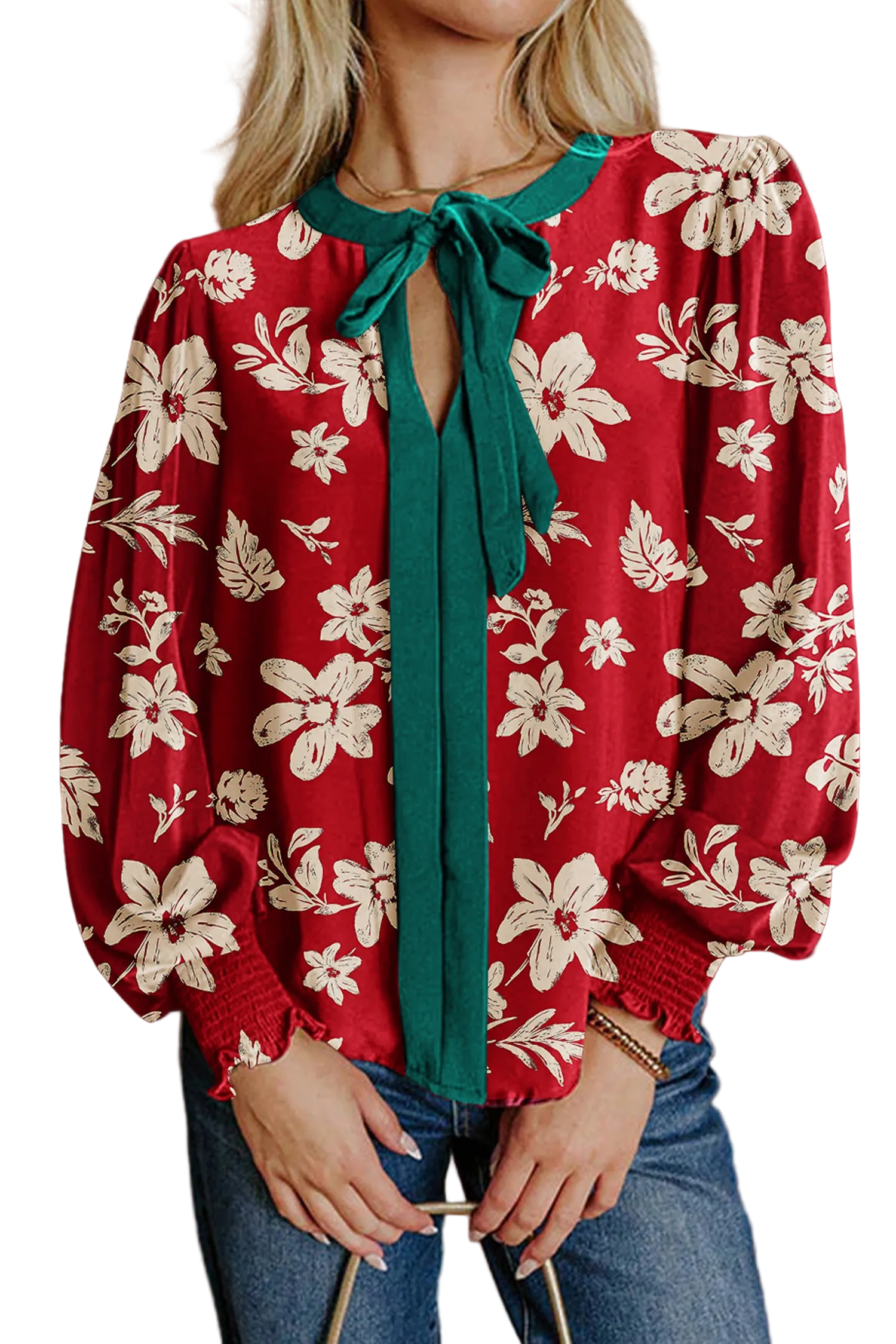 Red floral blouse with a green tie worn by a person against a brown background