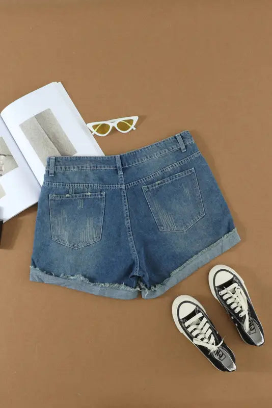 Distressed ripped denim shorts - rolled hem. Relax in stylish blue denim shorts with rolled cuffs