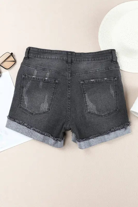 Distressed ripped denim: pair of gray shorts with frayed hems - relax relax in style