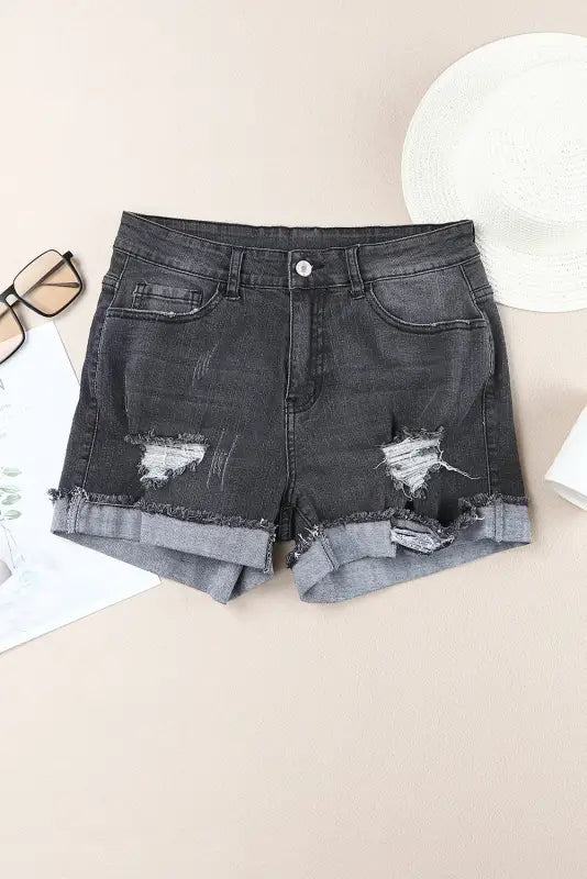 Distressed ripped denim shorts with rolled cuffs for a relaxed, edgy look