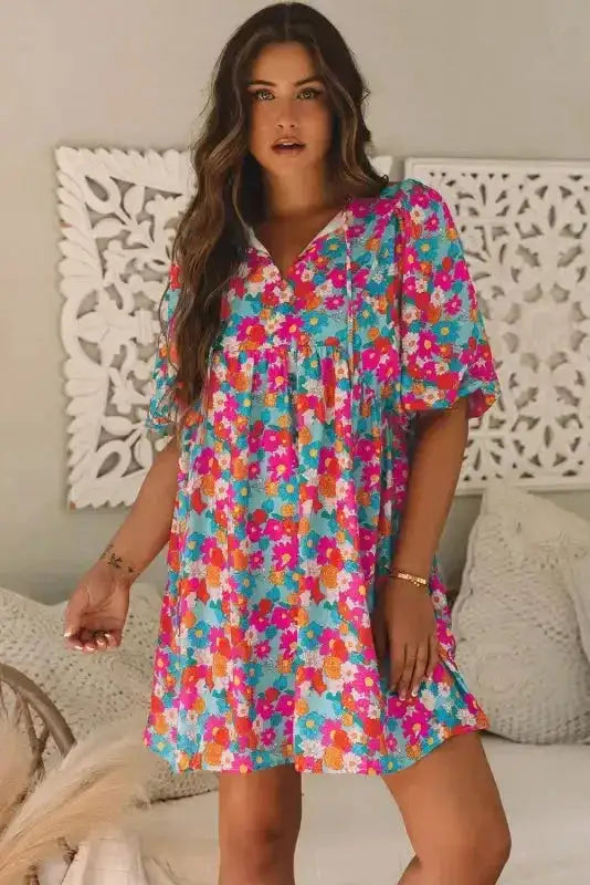 Woman modeling sky blue floral babydoll dress with bubble sleeves and relaxed fit, styled for a chic and breezy summer outfit.