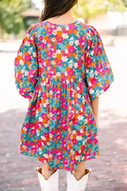 Back view of sky blue floral babydoll dress featuring multicolor print and puffed bubble sleeves in a relaxed A-line silhouette.