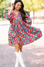 Model twirling in a sky blue floral babydoll dress with bubble sleeves, showcasing its flowy A-line fit and vibrant summer print.
