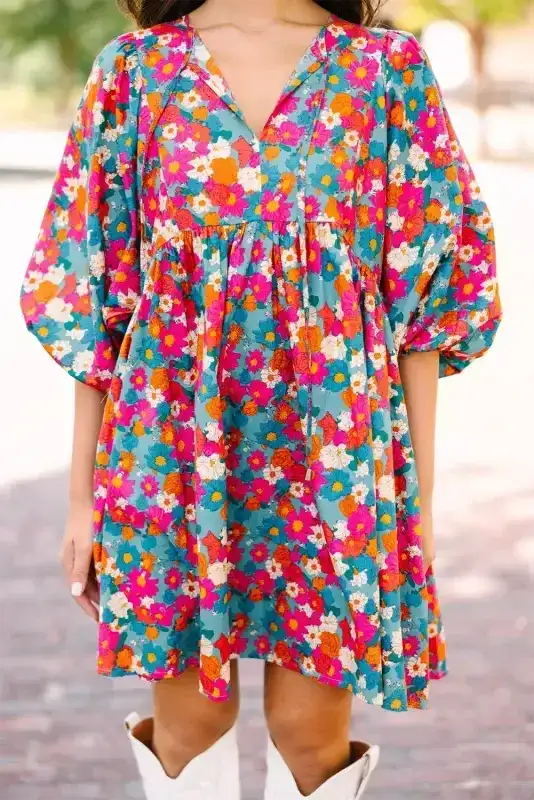 Sky blue floral babydoll dress with bubble sleeves and V-neckline, styled with white boots for a casual summer look.
