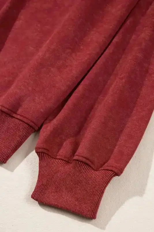Sleeve cuff detail of red Drop Shoulder Crew Neck Sweatshirt, featuring ribbed knit for added comfort and warmth.