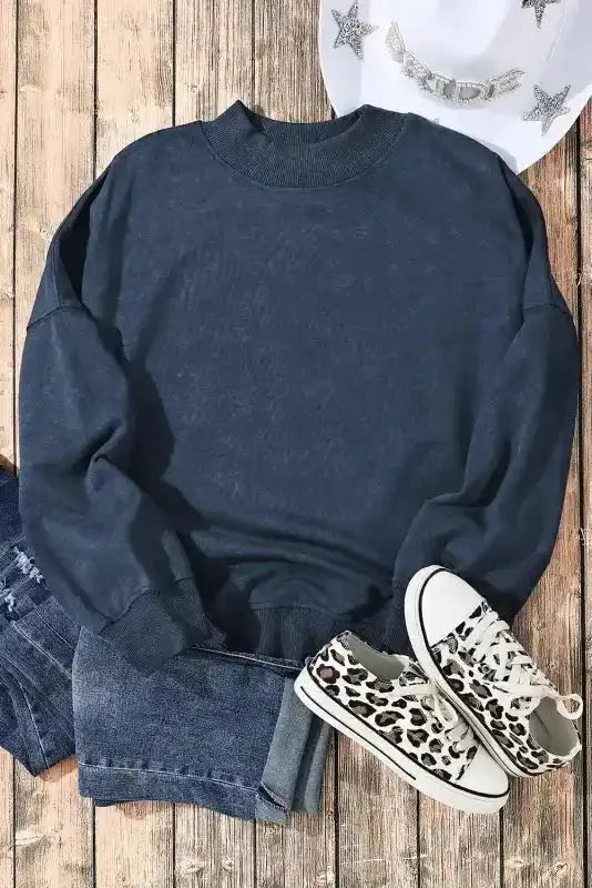 Flat lay of Drop Shoulder Crew Neck Sweatshirt with leopard sneakers and denim, styled for a casual winter outfit.