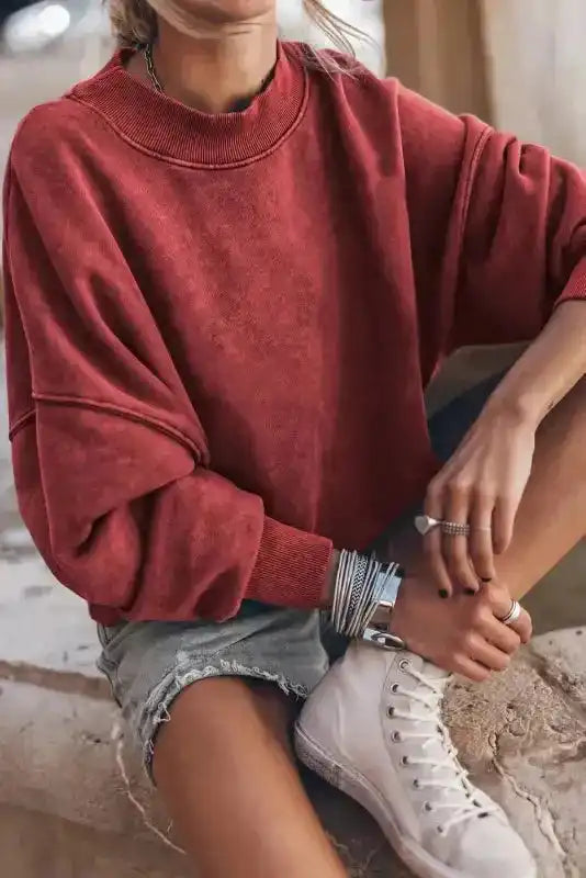 Red Drop Shoulder Crew Neck Sweatshirt paired with sneakers and bracelets, perfect for a stylish and cozy winter outfit.