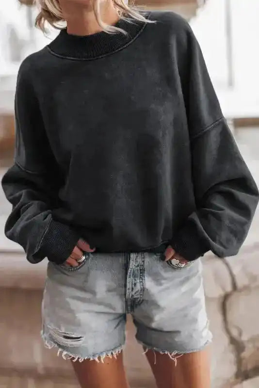 Model in black Cozy Drop Shoulder Crew Neck Sweatshirt paired with distressed shorts, perfect for a relaxed and stylish winter look.