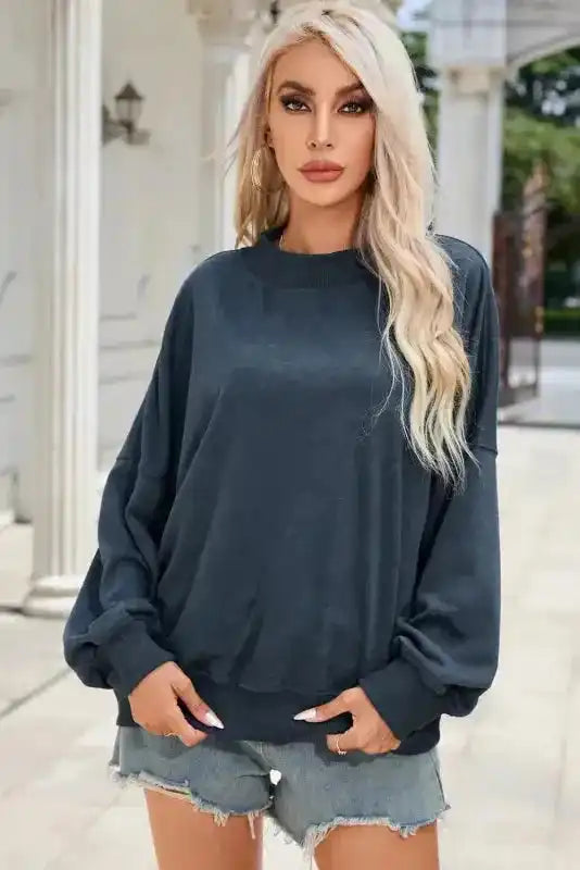 Solid color Drop Shoulder Crew Neck Sweatshirt with relaxed fit, ideal for layering in winter fashion.