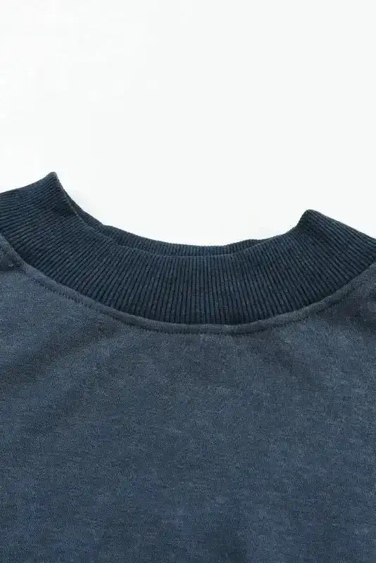 Close-up of ribbed crew neckline on Drop Shoulder Sweatshirt, highlighting its cozy and durable construction.