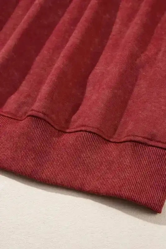 Bottom hem detail of red Drop Shoulder Crew Neck Sweatshirt with ribbed texture for a snug and stylish fit.