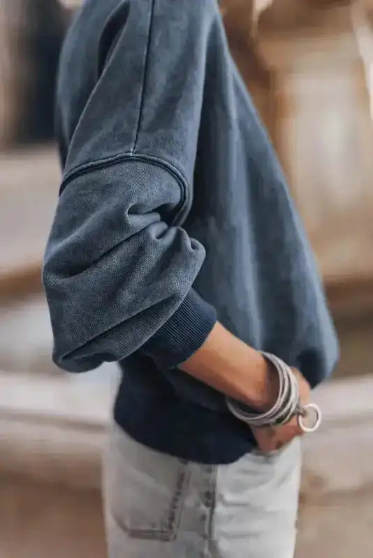 Side view of the Drop Shoulder Crew Neck Sweatshirt showing ribbed cuffs and relaxed sleeve design.