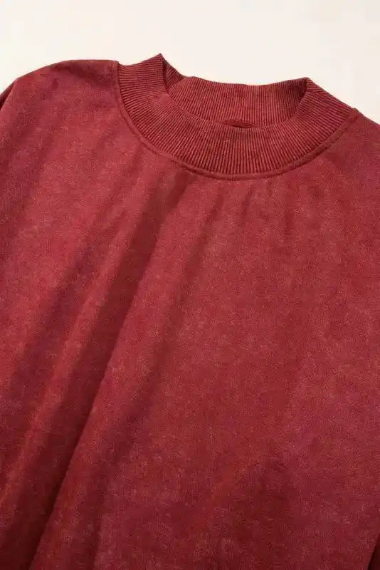 Close-up of ribbed crew neckline on red Drop Shoulder Sweatshirt, emphasizing its cozy and durable construction.