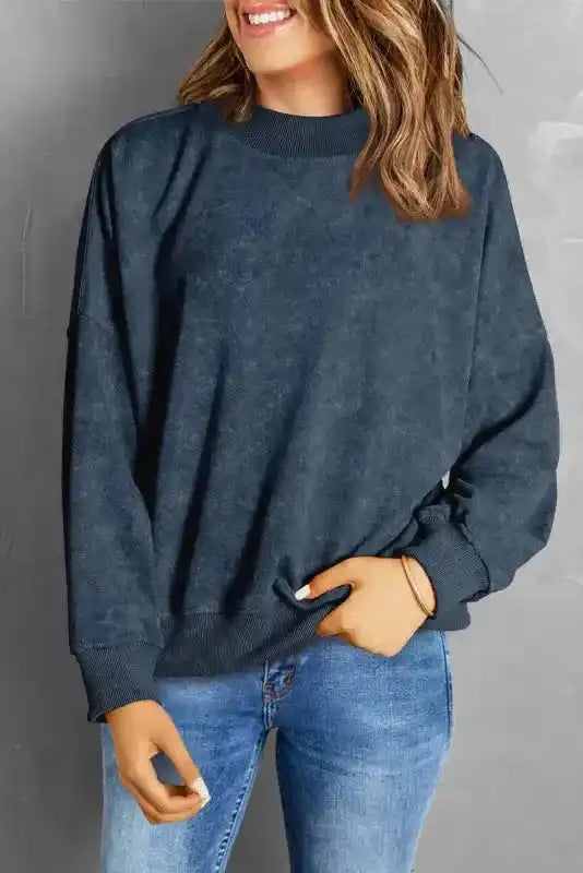 Smiling model wearing Drop Shoulder Crew Neck Sweatshirt with jeans, showcasing its cozy and versatile style.