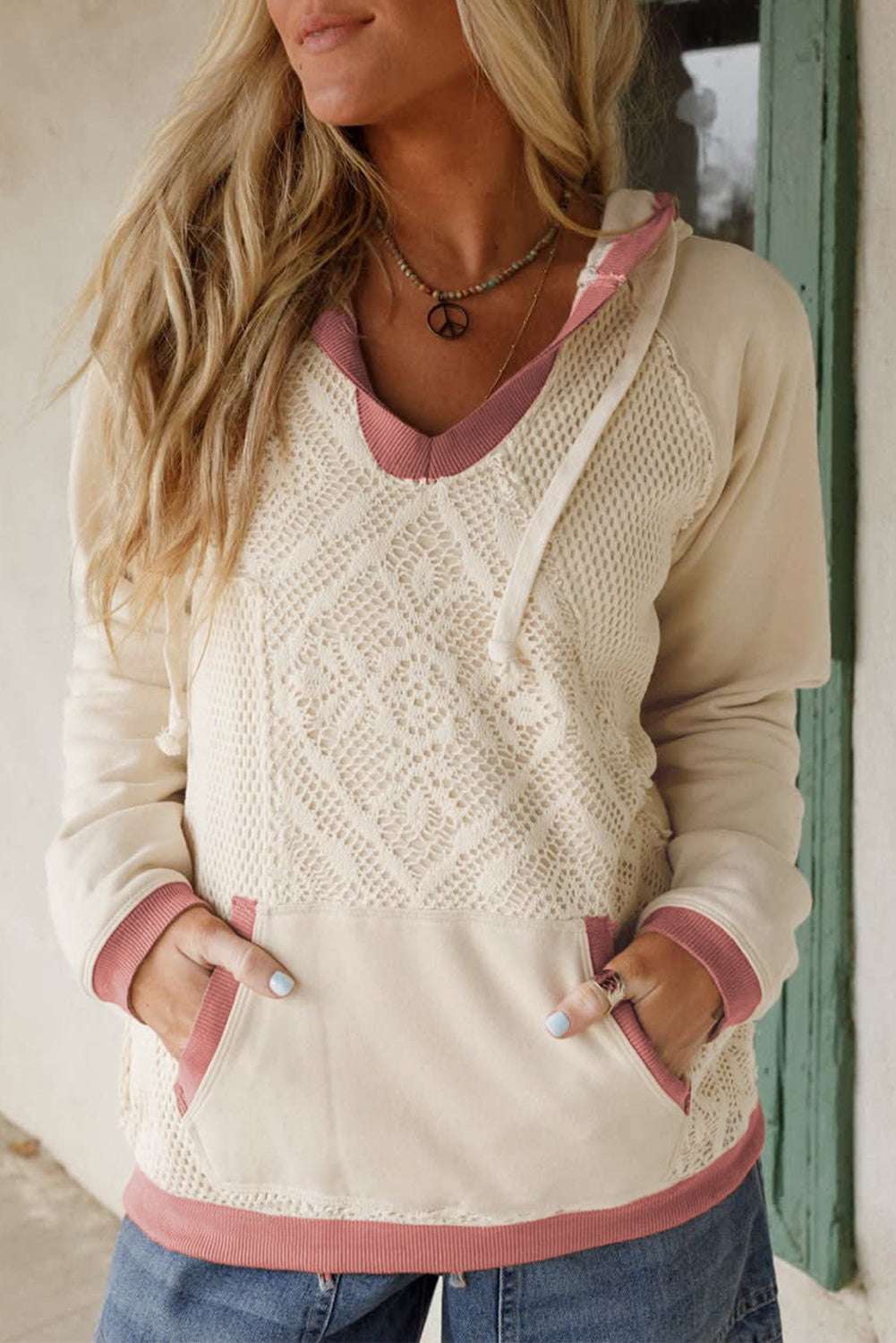 Women's White Contrast Trim Crochet Knit Hoodie with lace front panel and pink ribbed trim, styled casually with jeans for fall fashion.