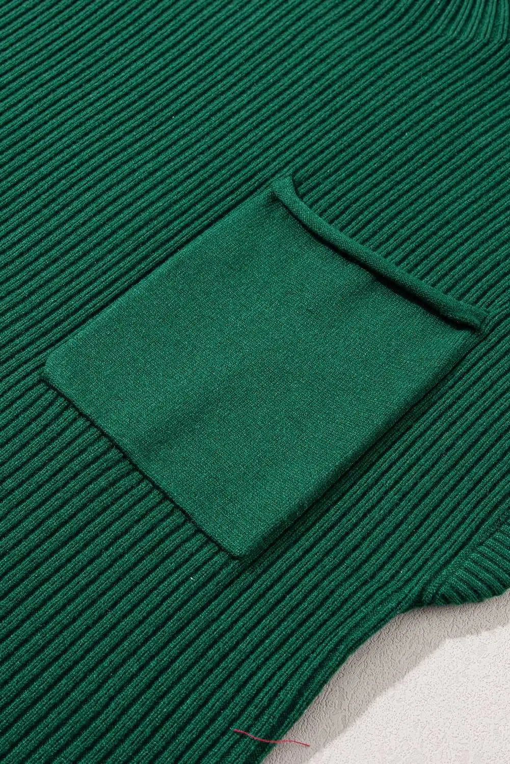 Close-up of green ribbed knit short sleeve sweater with chest pocket, showcasing soft texture and stylish design for casual wear.