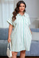 Woman wearing a green and white striped dress holding a white handbag in a living room.