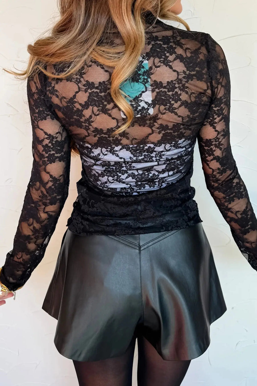Women's black mock neck lace top side view casual