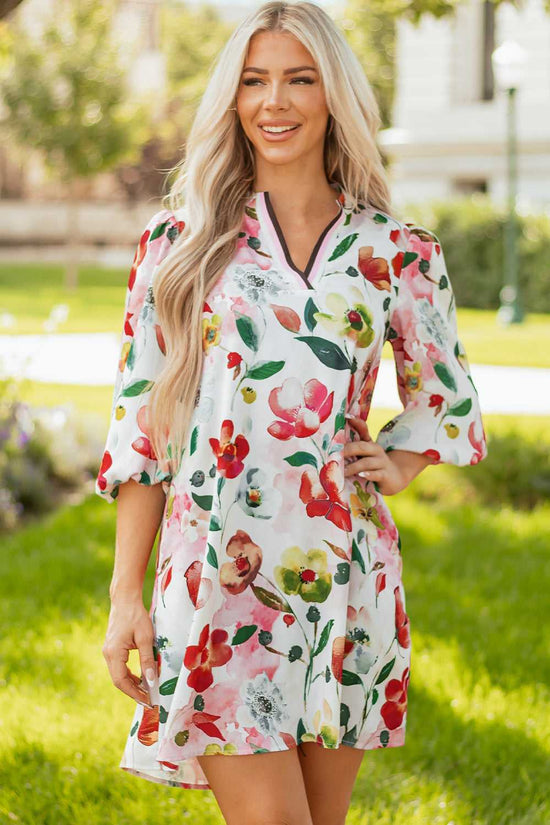 Model in Floral Shift Dress - Casual Elegance with hands on hips, emphasizing contrast neckline and vibrant floral design.