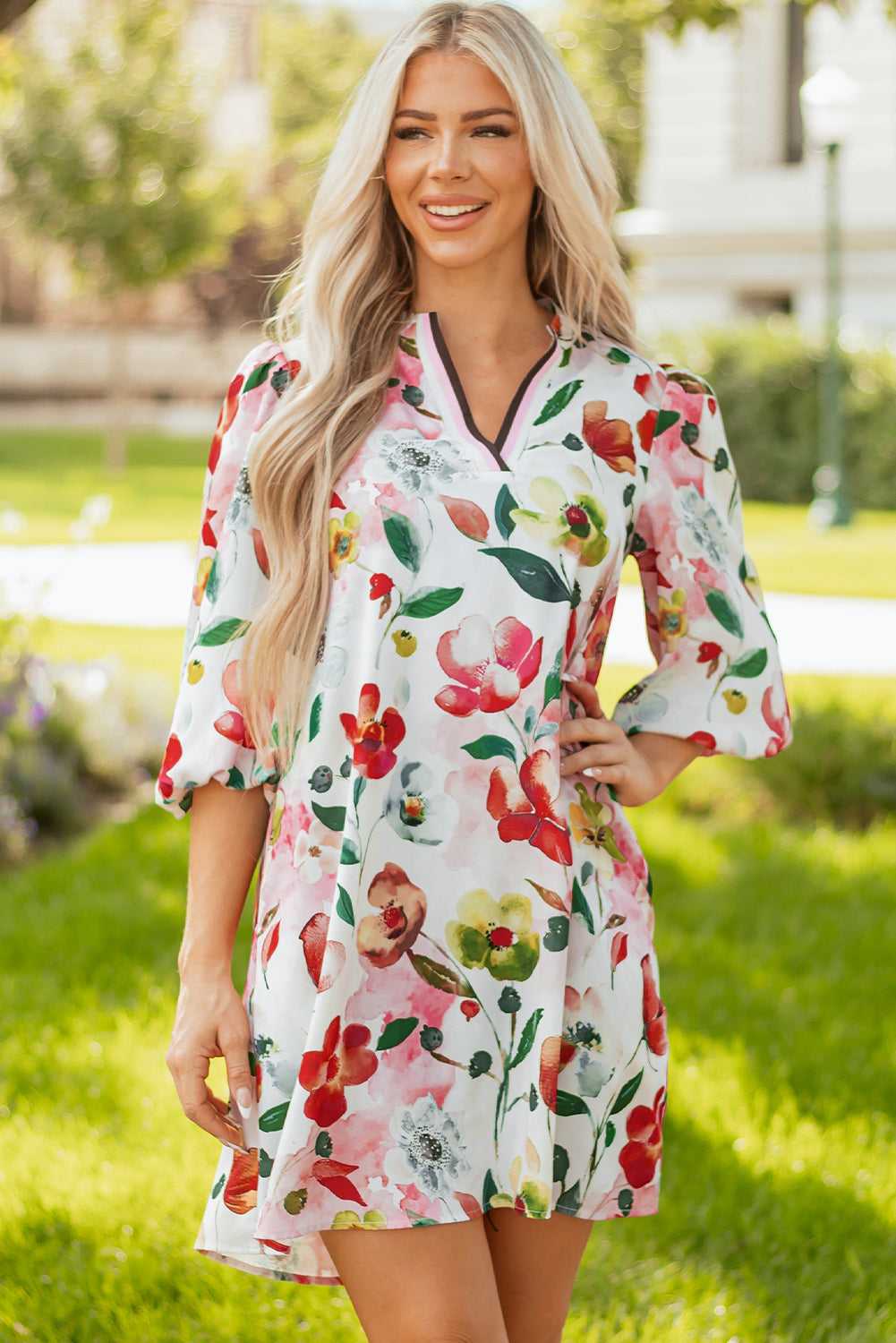 Model in Floral Shift Dress - Casual Elegance with hands on hips, emphasizing contrast neckline and vibrant floral design.