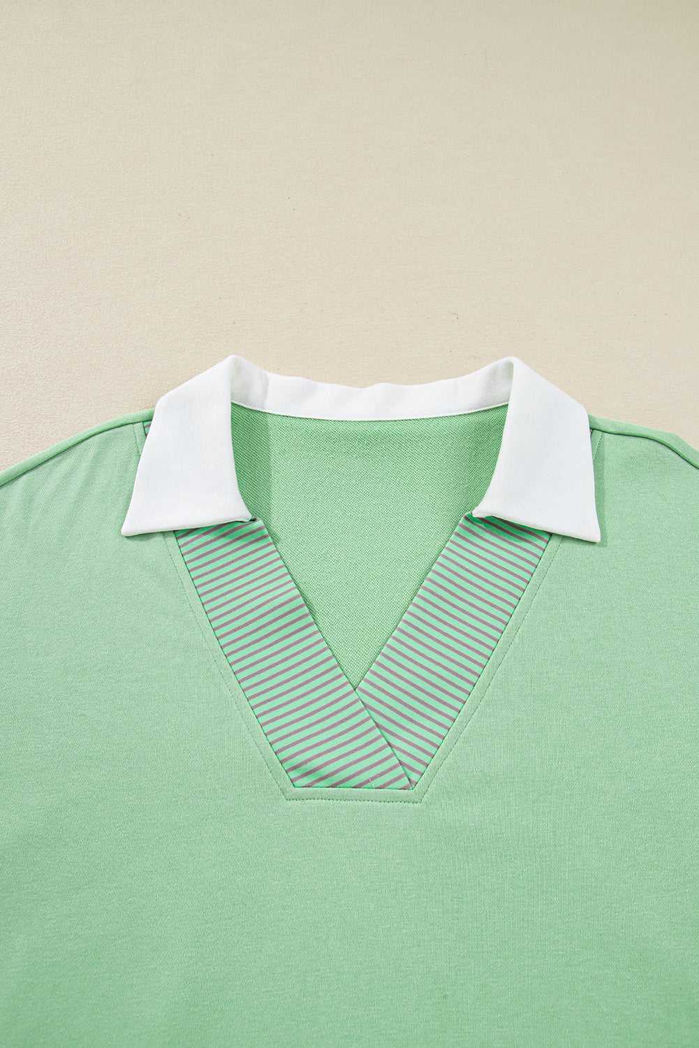 Detail shot of Curve Jade Stripe V‑Neck Sweatshirt for Women focusing on striped V-neck and white collar design.