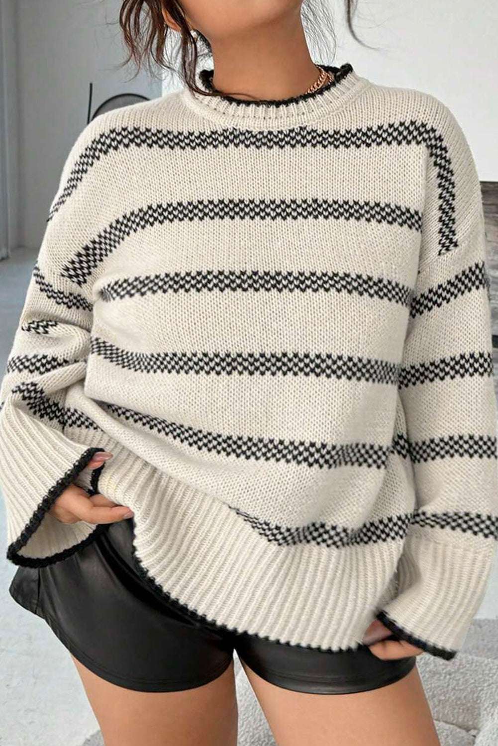 Women's Apricot Striped Bell Sleeve Jumper styled with black shorts, showcasing relaxed fit and cozy knit texture. Ideal for casual fall outfits.